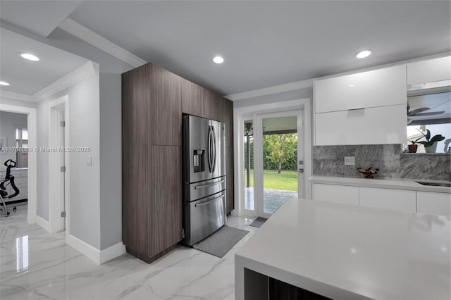 kitchen featuring marble finish floor, modern cabinets, and stainless steel refrigerator with ice dispenser