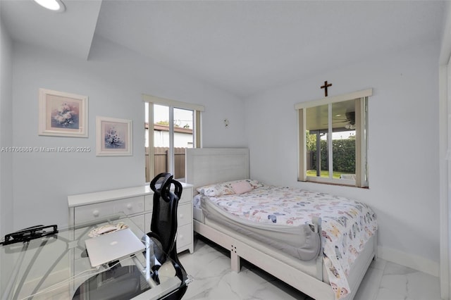 bedroom featuring baseboards, lofted ceiling, and marble finish floor