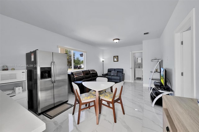 dining space with visible vents, marble finish floor, and baseboards