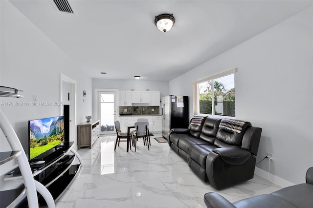 living room with visible vents, baseboards, and marble finish floor