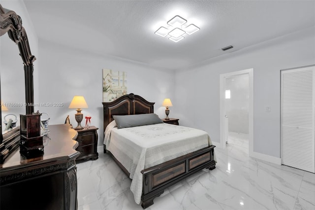 bedroom featuring visible vents, marble finish floor, a textured ceiling, and baseboards