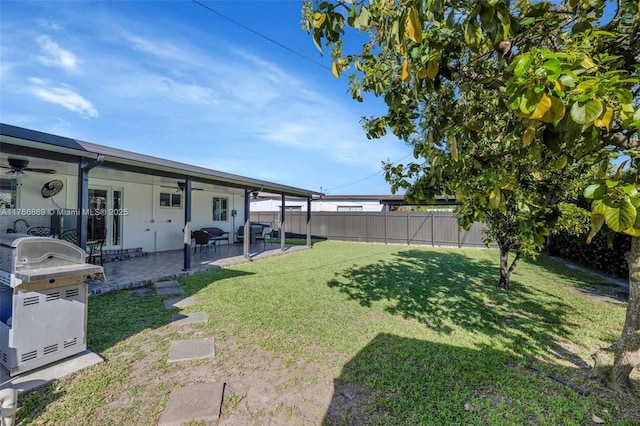 view of yard featuring a ceiling fan, a patio area, and a fenced backyard