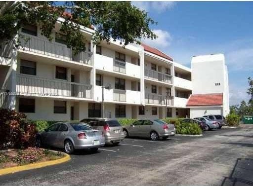 view of building exterior with uncovered parking