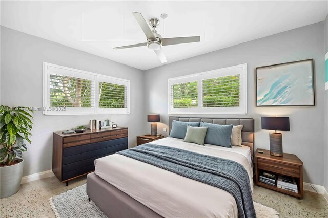 bedroom featuring light speckled floor, baseboards, and ceiling fan