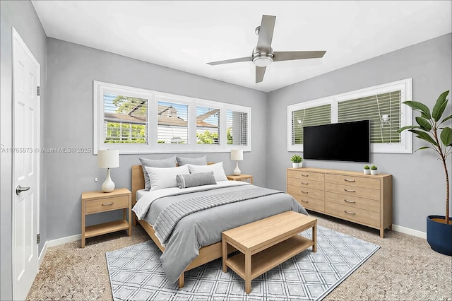 bedroom featuring baseboards, ceiling fan, and light colored carpet