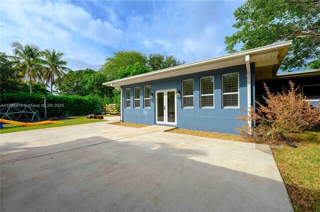 back of house featuring french doors, a patio, and stucco siding