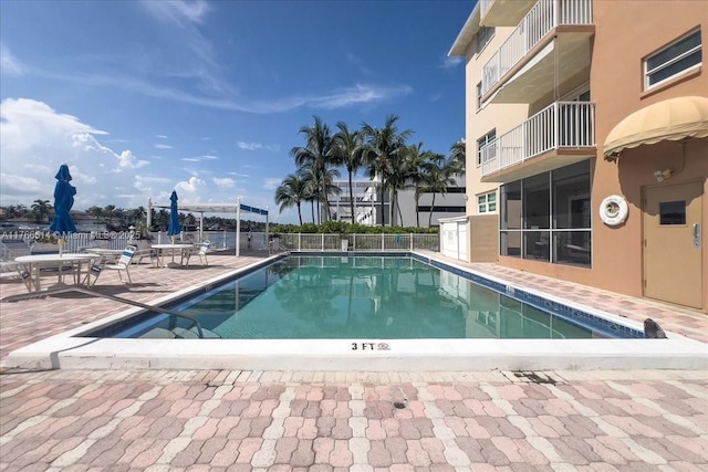 community pool featuring a patio area and fence
