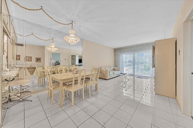 dining room with an inviting chandelier and light tile patterned floors
