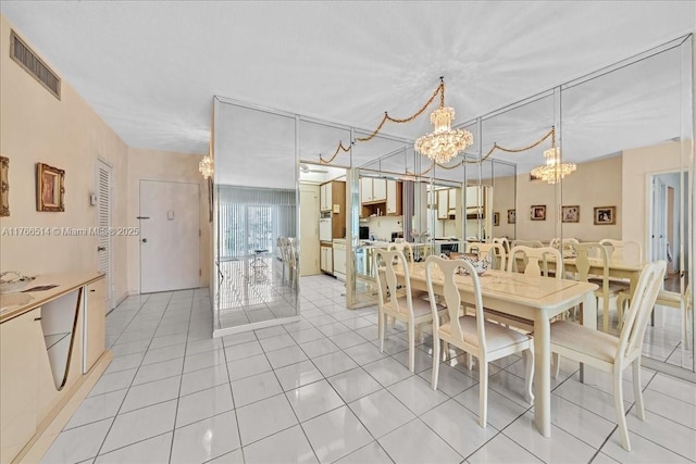 dining room featuring light tile patterned floors, visible vents, and a chandelier