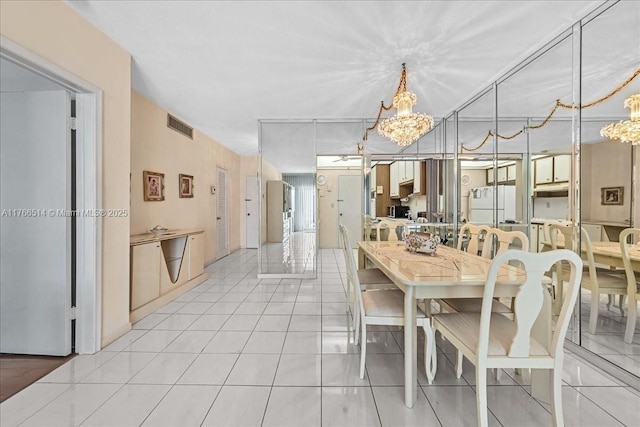 dining room with visible vents, an inviting chandelier, and light tile patterned flooring
