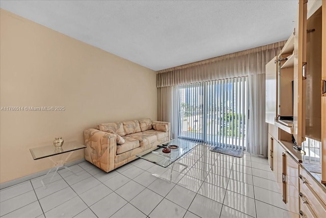 unfurnished living room featuring light tile patterned floors and a textured ceiling