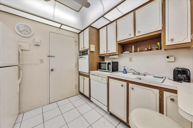 kitchen with a sink, light countertops, light tile patterned floors, white appliances, and open shelves