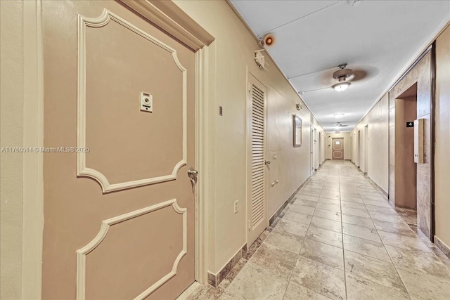 corridor with light tile patterned floors