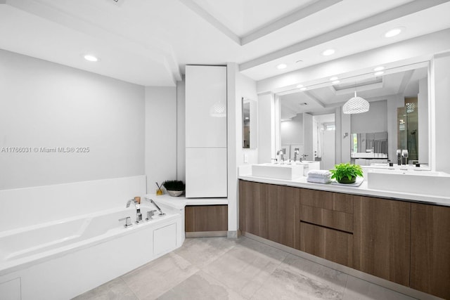 bathroom featuring a tray ceiling, double vanity, a stall shower, a sink, and a garden tub