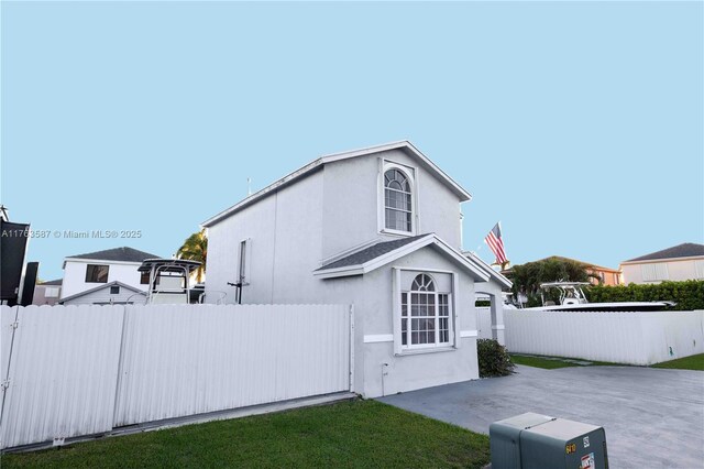 14016 SW 160th St, Miami, FL 33177 - view of side of property featuring stucco siding, a patio, and fence