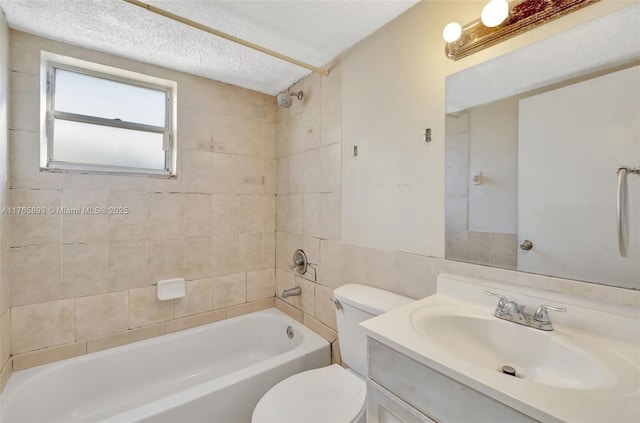 bathroom with toilet, vanity, washtub / shower combination, and a textured ceiling