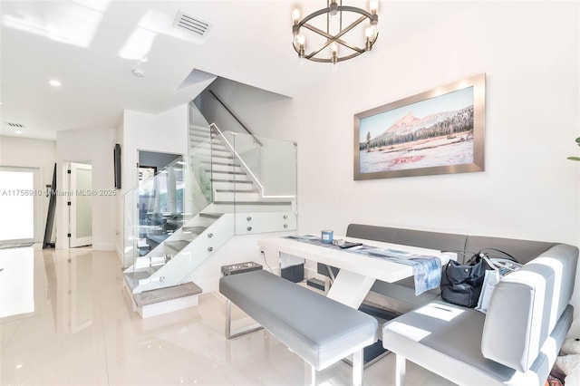 dining space featuring visible vents, a notable chandelier, and stairway