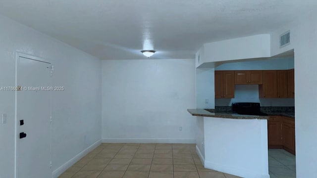 5102 NW 79th Ave Unit 304, Doral, FL 33166 - kitchen with visible vents, baseboards, a peninsula, brown cabinetry, and electric range