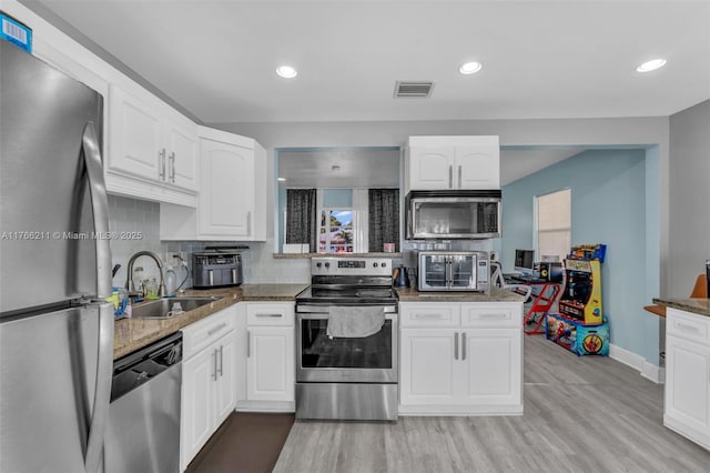 2813 SW 67th Ln, Miramar, FL 33023 - kitchen with visible vents, white cabinets, appliances with stainless steel finishes, and a sink