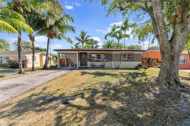 2813 SW 67th Ln, Miramar, FL 33023 - ranch-style house featuring stucco siding, an attached carport, concrete driveway, and a front lawn