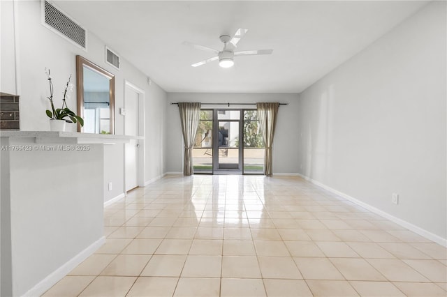 3040 NE 16th Ave Unit 104, Oakland Park, FL 33334 - empty room with light tile patterned floors, ceiling fan, and baseboards