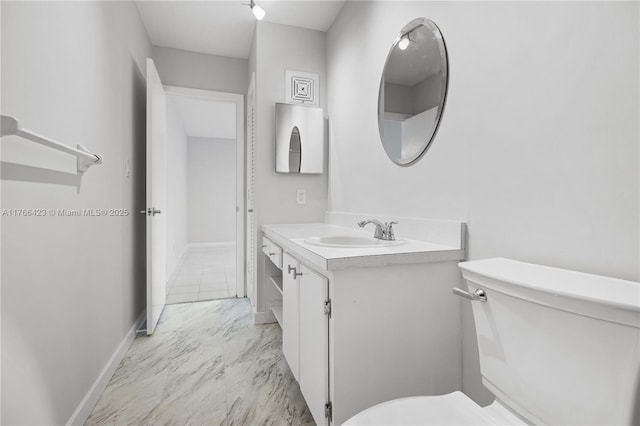 3040 NE 16th Ave Unit 104, Oakland Park, FL 33334 - bathroom featuring toilet, marble finish flooring, vanity, and baseboards