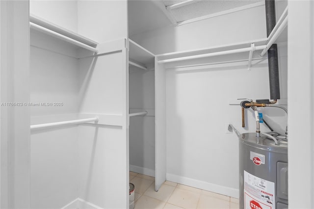 3040 NE 16th Ave Unit 104, Oakland Park, FL 33334 - walk in closet featuring water heater and tile patterned floors