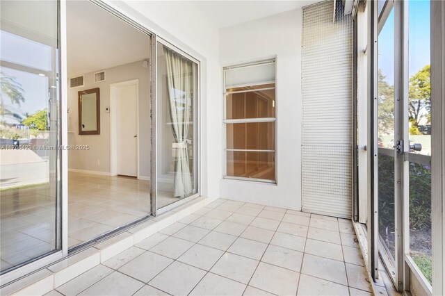 3040 NE 16th Ave Unit 104, Oakland Park, FL 33334 - unfurnished sunroom featuring plenty of natural light