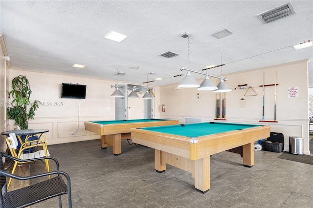 3040 NE 16th Ave Unit 104, Oakland Park, FL 33334 - rec room featuring a textured ceiling, billiards table, a decorative wall, and a wainscoted wall