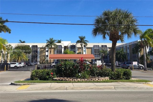 3040 NE 16th Ave Unit 104, Oakland Park, FL 33334 - view of building exterior featuring uncovered parking