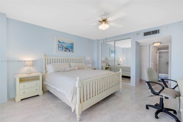 bedroom with a closet, visible vents, a ceiling fan, and light tile patterned floors