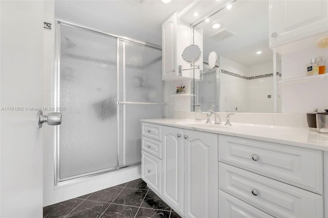 bathroom featuring visible vents, vanity, marble finish floor, and a shower stall
