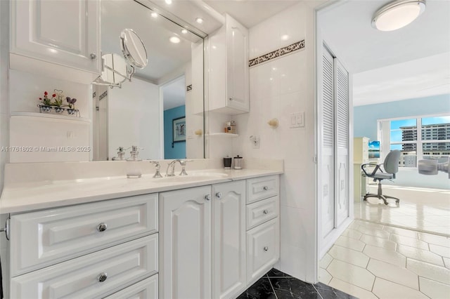 bathroom with vanity and tile walls