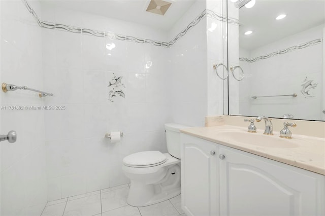 bathroom with toilet, tile walls, and vanity