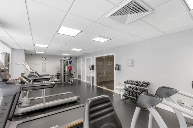 workout area featuring visible vents and a paneled ceiling
