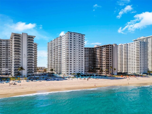 view of swimming pool featuring a city view, a beach view, and a water view