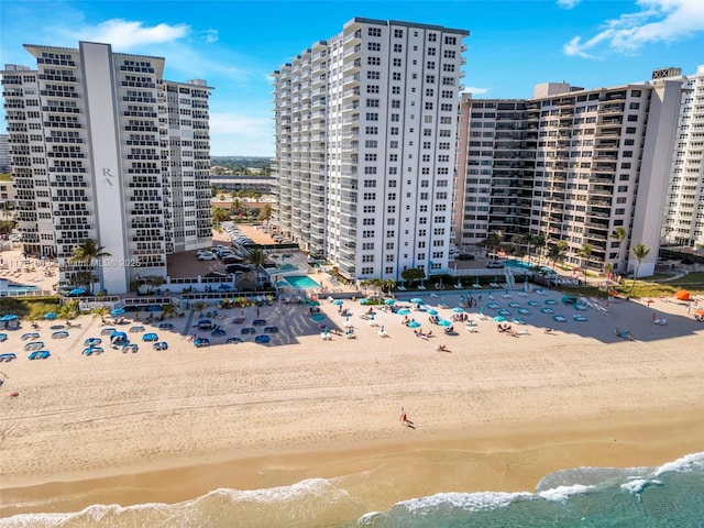 exterior space featuring a city view, a view of the beach, and a water view