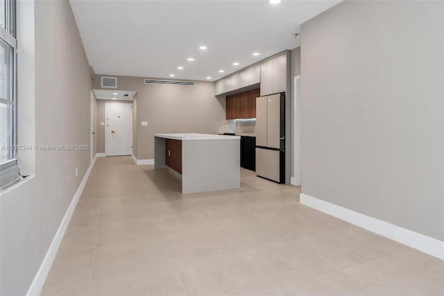 5255 Collins Ave Unit 9B, Miami Beach, FL 33140 - kitchen featuring freestanding refrigerator, modern cabinets, light countertops, recessed lighting, and a kitchen island