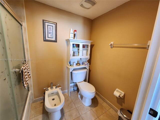 4242 NW 2nd St Unit 1202, Miami, FL 33126 - bathroom featuring a bidet, baseboards, an enclosed shower, tile patterned floors, and toilet