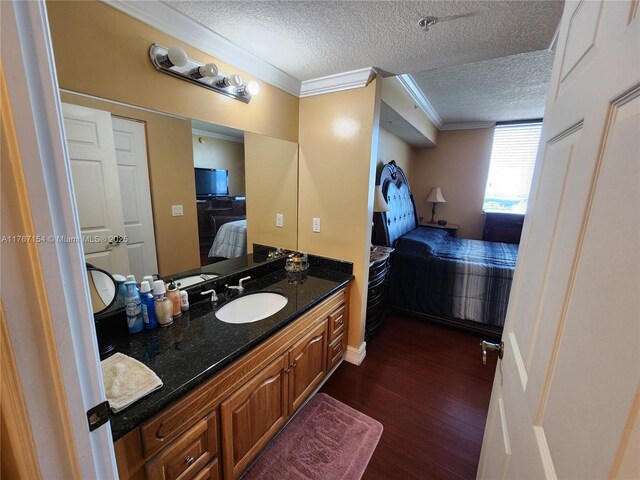 4242 NW 2nd St Unit 1202, Miami, FL 33126 - ensuite bathroom with vanity, wood finished floors, ensuite bath, ornamental molding, and a textured ceiling