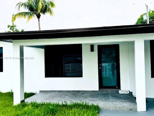 11730 NW 3rd Ave, Miami, FL 33168 - doorway to property featuring stucco siding