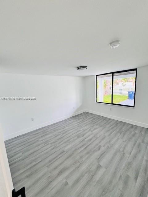 11730 NW 3rd Ave, Miami, FL 33168 - spare room with baseboards and wood finished floors