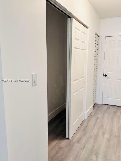11730 NW 3rd Ave, Miami, FL 33168 - corridor featuring light wood-type flooring and baseboards