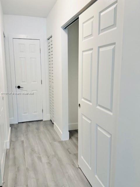 11730 NW 3rd Ave, Miami, FL 33168 - hall featuring light wood-type flooring and baseboards