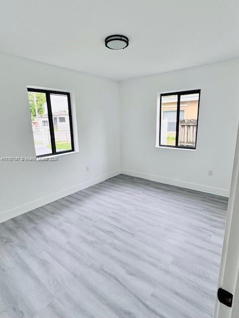 11730 NW 3rd Ave, Miami, FL 33168 - empty room featuring baseboards and wood finished floors