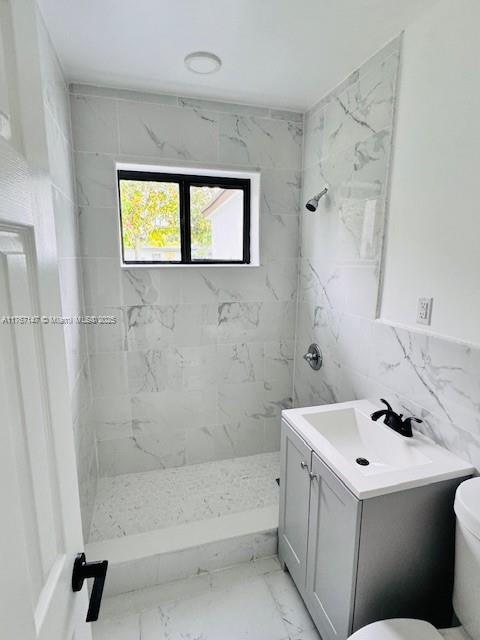 11730 NW 3rd Ave, Miami, FL 33168 - bathroom with vanity, a stall shower, tile walls, toilet, and marble finish floor