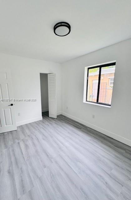 11730 NW 3rd Ave, Miami, FL 33168 - spare room with baseboards and wood finished floors