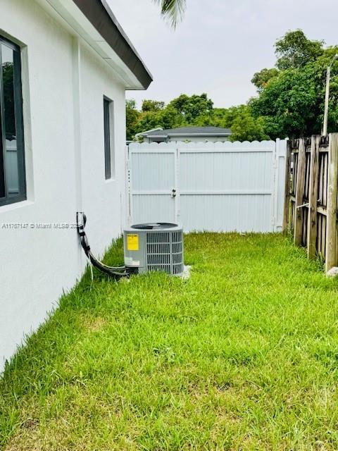 11730 NW 3rd Ave, Miami, FL 33168 - view of yard with central AC unit and fence