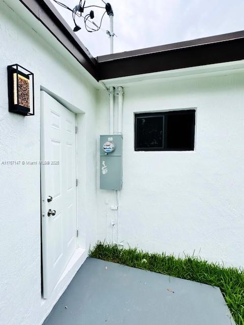 11730 NW 3rd Ave, Miami, FL 33168 - doorway to property featuring stucco siding