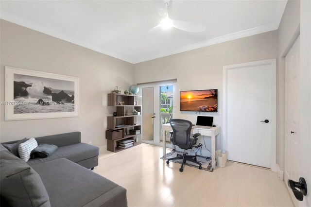 home office with a ceiling fan, crown molding, and wood finished floors